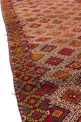Primer plano de la alfombra kilim doblada, resaltando la textura y la combinación de colores.