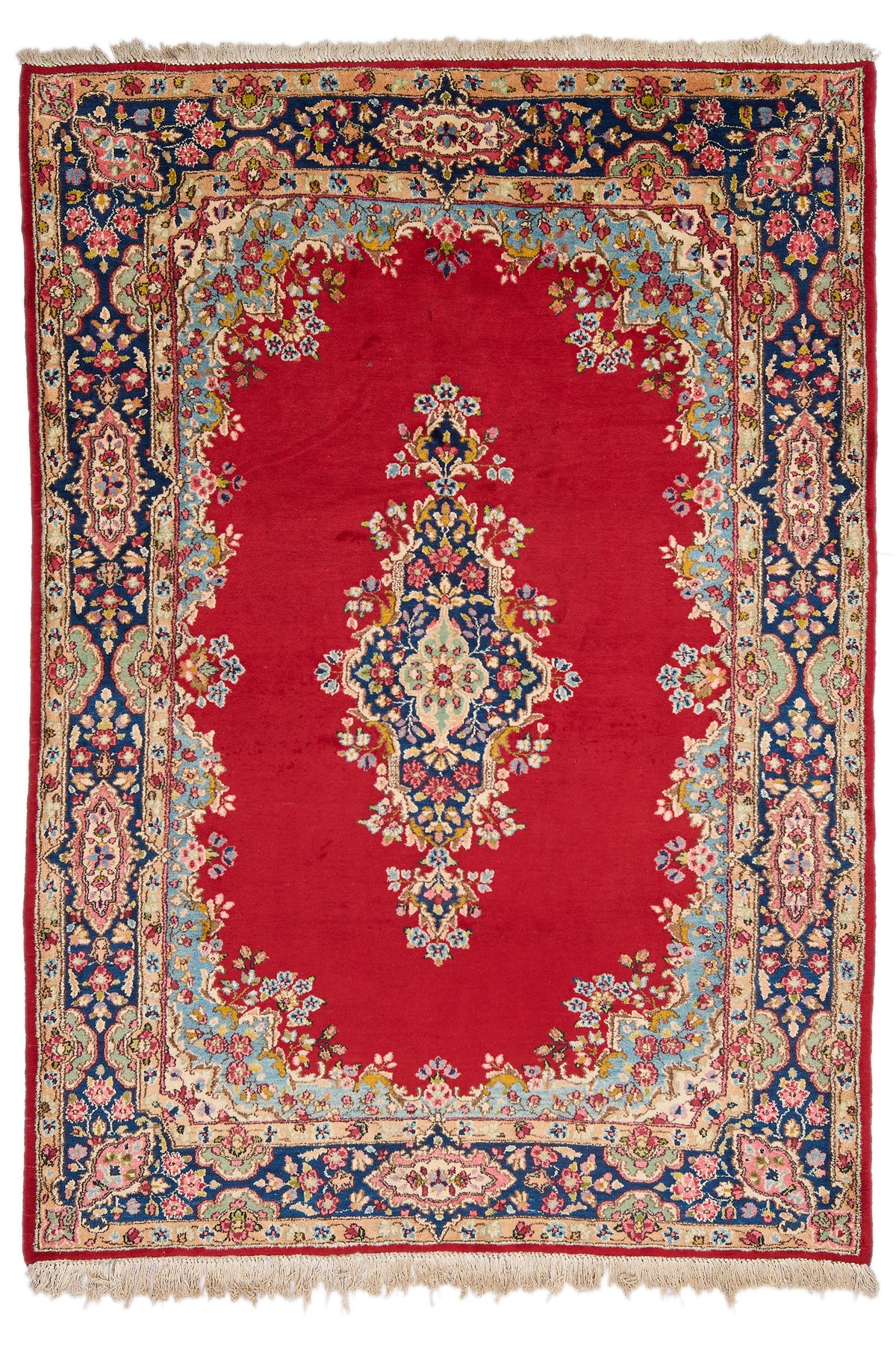 Alfombra persa con fondo rojo intenso y medallón central floral en tonos azul marino, verde y rosa, rodeado por un marco floral decorativo en colores celeste, beige y azul marino.