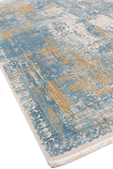 Primer plano en ángulo mostrando la textura y diseño deslavado de la alfombra con bordes trabajados.
