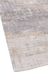 Detalle del borde de la alfombra, resaltando la transición entre las áreas claras y sombreadas del diseño.
