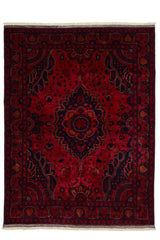 Alfombra persa con fondo rojo intenso y medallón central azul oscuro con detalles en rojo y dorado, vista completa desde arriba.