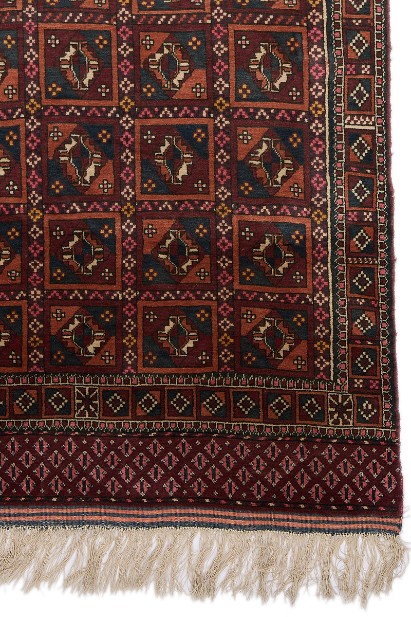 Detalle de la esquina inferior derecha de la alfombra con patrones simétricos y borde decorativo.