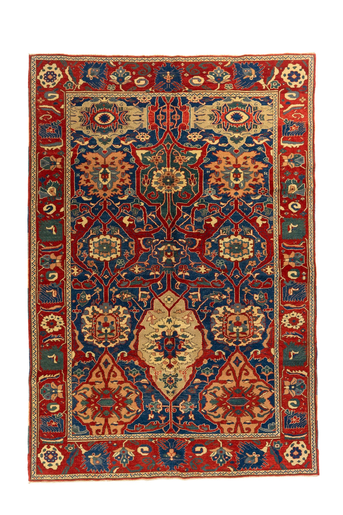 Alfombra clásica oriental en rojo y azul con diseño geométrico simétrico y guarda decorativa, vista completa