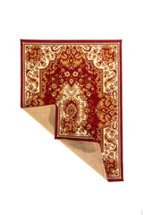 Alfombra de estilo clásico en color rojo y blanco suave con una esquina doblada, mostrando el reverso del tejido y su diseño ornamental.