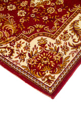 Detalle en perspectiva de esquina de alfombra roja con fondo blanco suave, patrones florales elegantes y borde decorativo fino.
