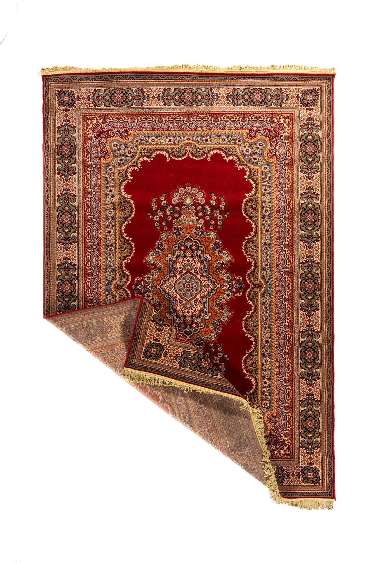 Alfombra oriental roja con una esquina doblada que deja ver el reverso, el tejido interior, la guarda decorativa y los flecos beige.