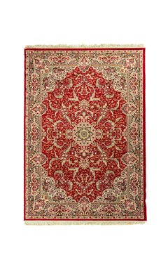 Alfombra clásica oriental de fondo rojo intenso con medallón central floral, guarda beige y detalles en negro, verde y blanco suave.