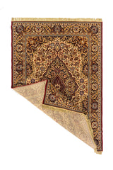 Alfombra clásica rectangular con una esquina doblada que muestra el reverso del tejido, los flecos y el detalle del diseño decorativo