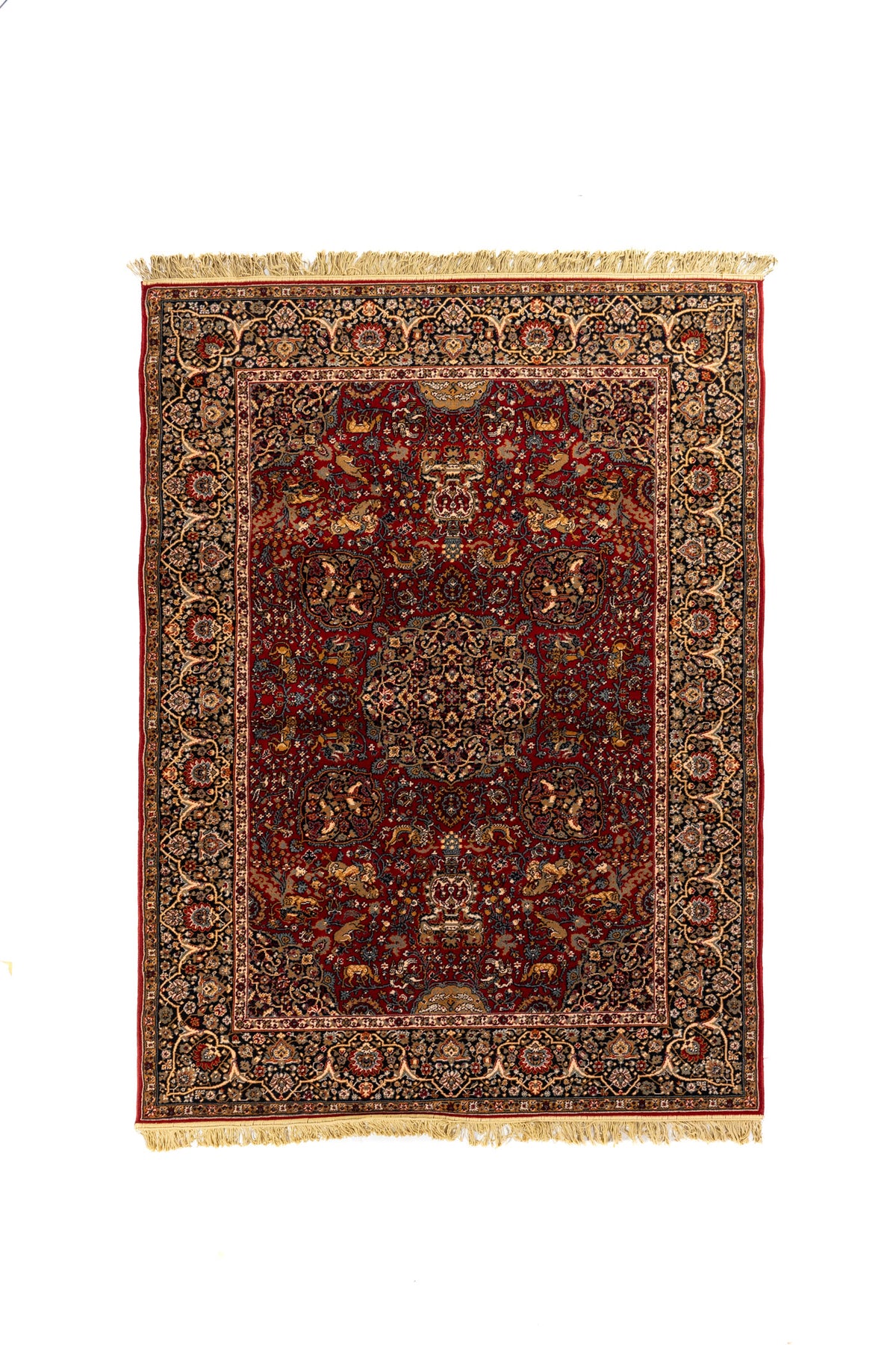 Alfombra clásica de estilo oriental en color rojo con medallón central, guarda azul marino y flecos beige.