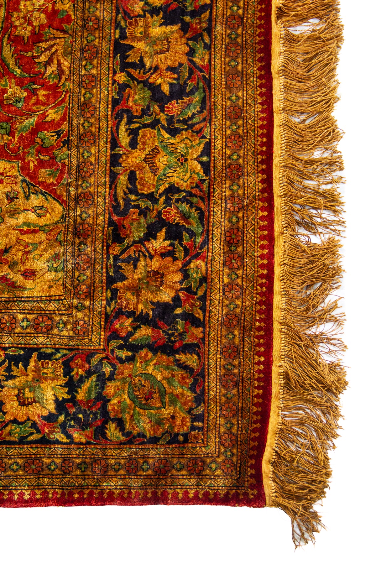 Detalle de guarda y flecos dorados de alfombra Ispahan Seda Fragmento floral