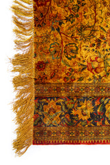 Detalle de flecos y diseño floral de alfombra Ispahan Seda Fragmento en tonos ocre y verde