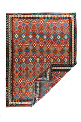 Alfombra Kilim multicolor con esquina doblada y patrón geométrico de rombos