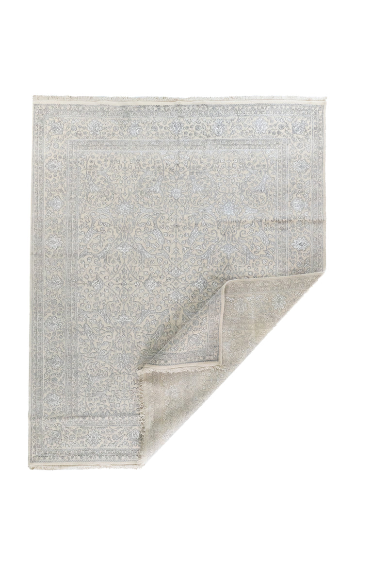 Alfombra Persa Nain beige con esquina doblada y diseño floral ornamental