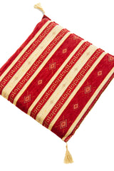 Almohadón cuadrado rojo y beige con diseño de rayas horizontales y borlas en las esquinas