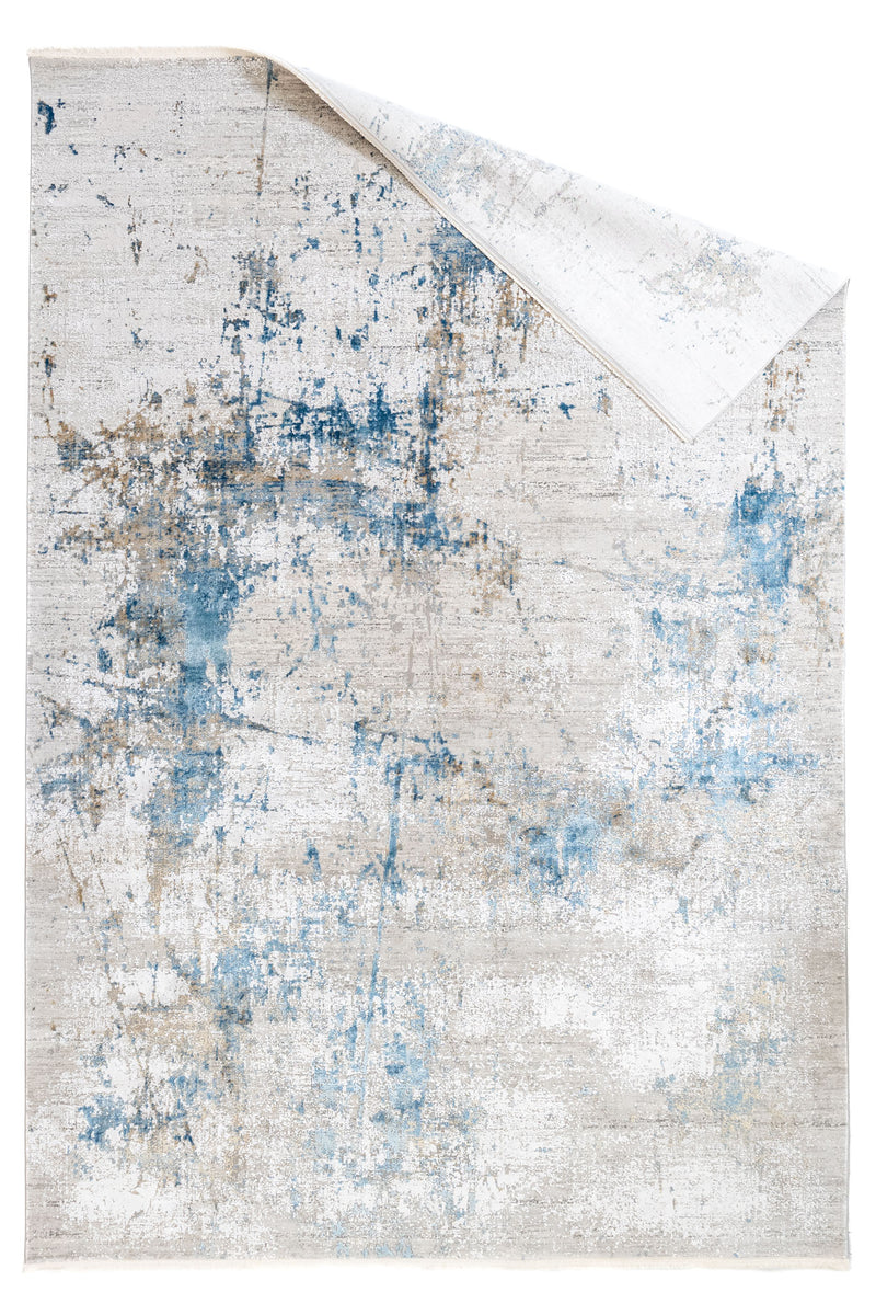 Alfombra con la esquina doblada mostrando la continuidad del patrón en el reverso.