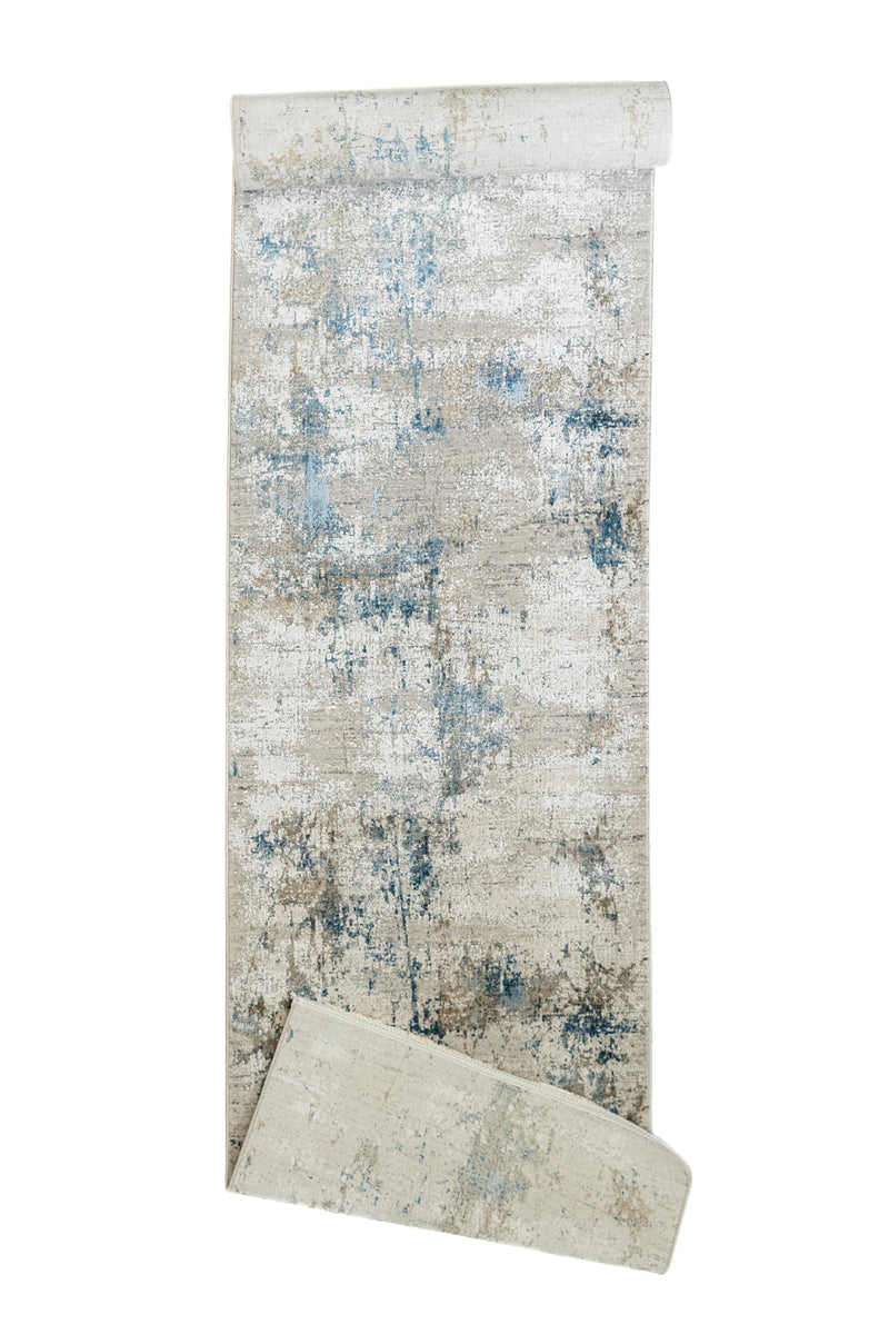 Alfombra parcialmente enrollada mostrando la parte inferior del diseño y el reverso liso de la pieza