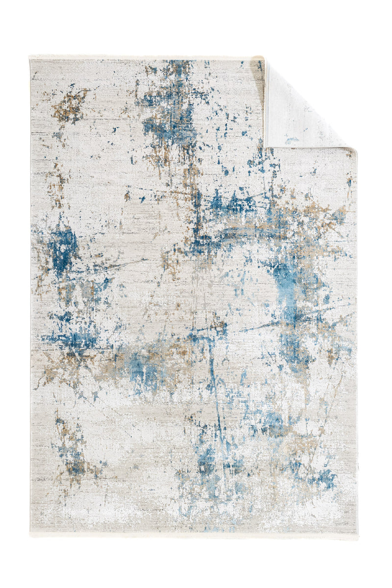 Vista de la alfombra con la esquina doblada, mostrando el reverso liso y la continuidad del diseño.