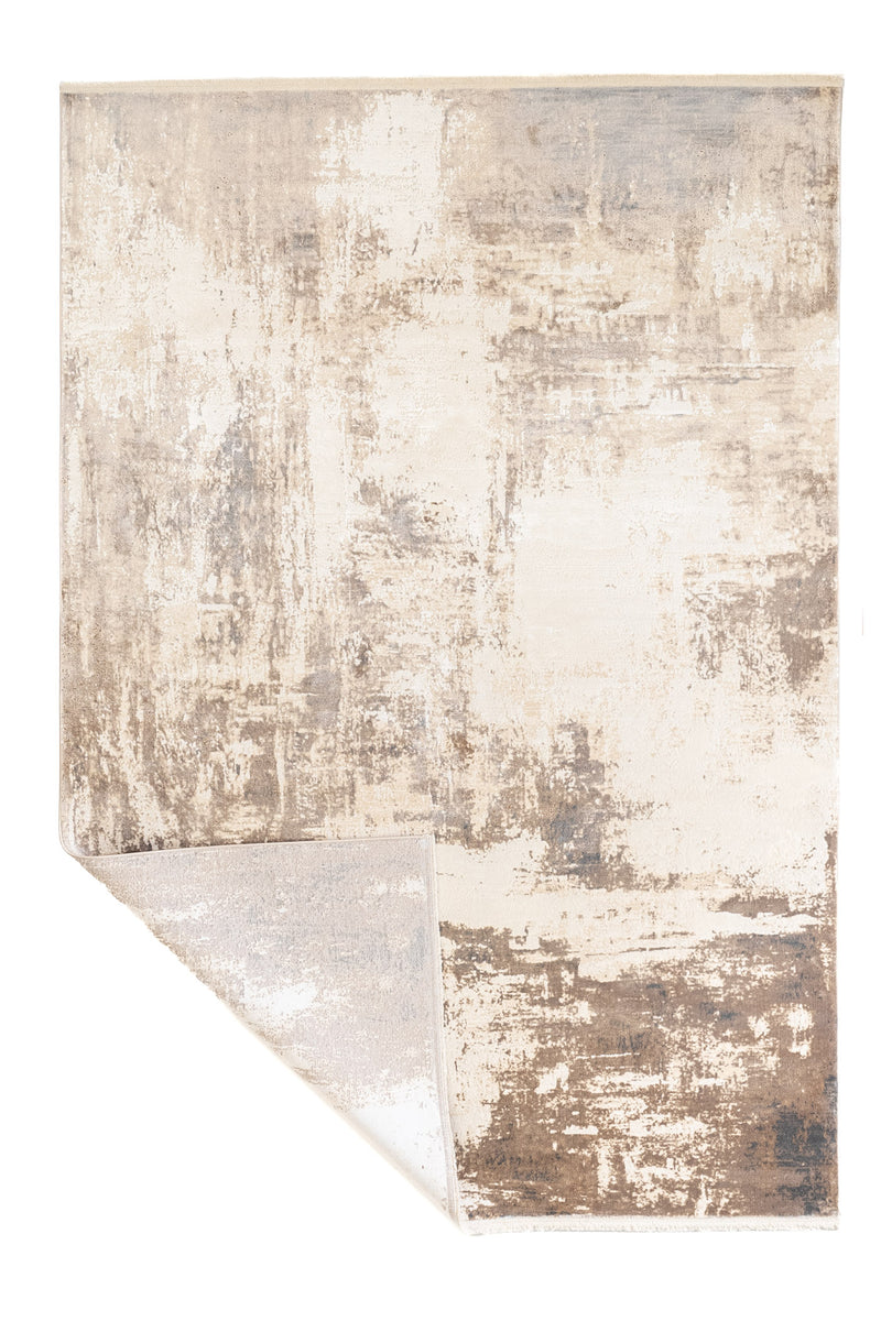 Alfombra con una esquina doblada mostrando el reverso, resaltando su flexibilidad y acabado limpio.