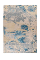 Alfombra Cosmic Blue rectangular con diseño abstracto pixelado en beige, celeste y gris