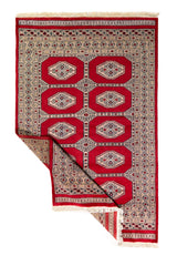 Alfombra Persa Yamouth rojo de 1.25 x 1.90 mts, vista completa con una esquina doblada; el diseño muestra dos columnas de medallones claros sobre un campo rojo y un borde geométrico oscuro