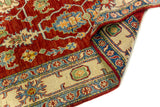 Alfombra Caucasica Kazak rojo de 1.80 x 2.60 mts, detalle de pliegue, reverso y terminación; se observan flores, hojas y enredaderas visibles dentro de una composición tradicional