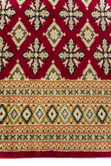 Alfombra Persa Yamouth rojo de 1.88 x 2.80 mts, detalle del campo y la guarda; se observan retícula geométrica densa con guarda ornamental