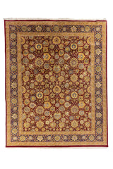 Alfombra clásica oriental en rojo con motivos florales y guarda azul marino, vista completa