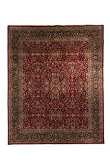 Alfombra clásica oriental en tono rojo profundo con diseño floral simétrico y guarda oscura decorada