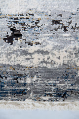Detalle de flecos y diseño abstracto de alfombra Marble Grey en gris, blanco y azul
