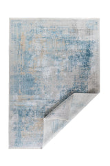 Alfombra Nordic Blue rectangular con esquina doblada y diseño abstracto en tonos azul y gris
