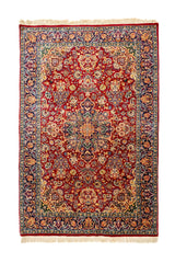 Alfombra vista completa con fondo rojo y detallado diseño floral en tonos azules, verdes, beige y dorado.