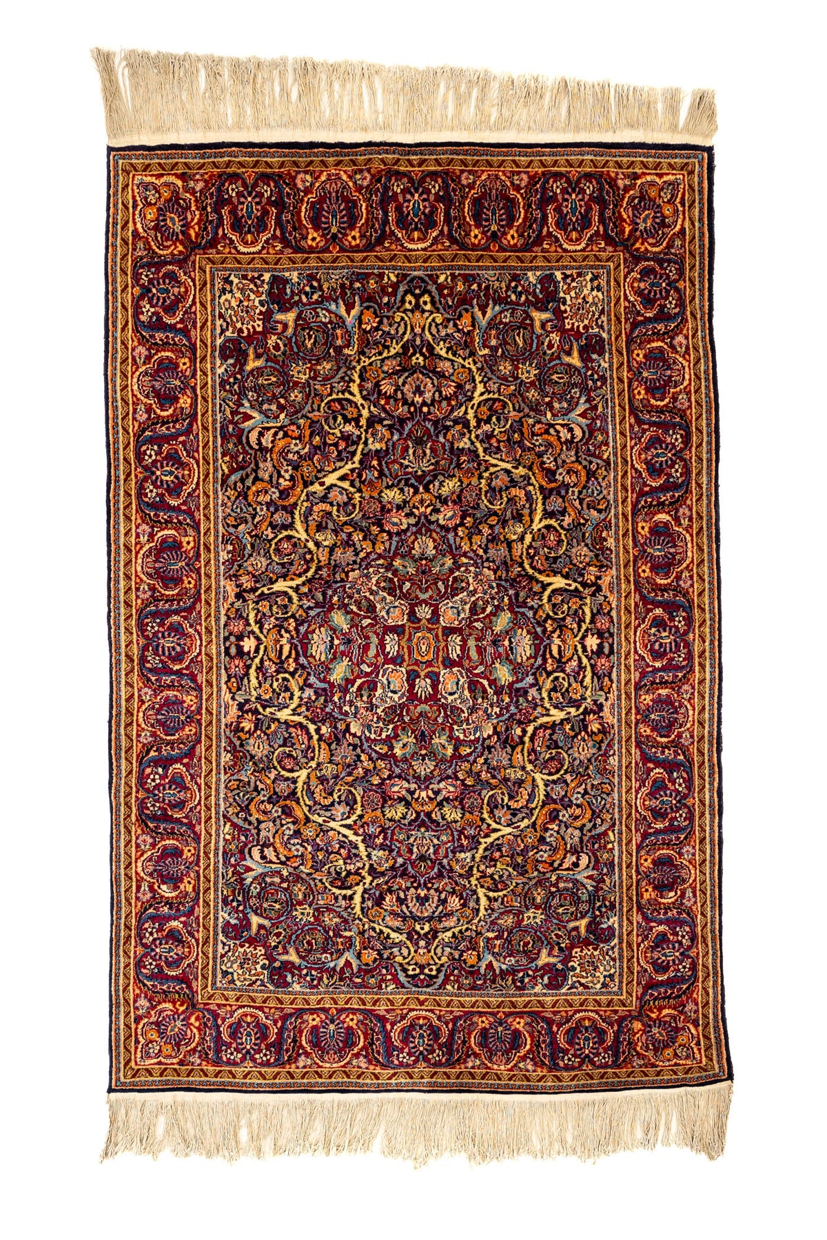 Alfombra rectangular con fondo burdeos y diseño floral intrincado en tonos dorados, azules y naranjas, con flecos en los extremos.