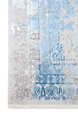 Detalle de guarda de alfombra Palace Blue con motivos geométricos en celeste y gris 