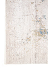 Detalle del borde de alfombra rectangular gris con diseño abstracto en celeste suave.