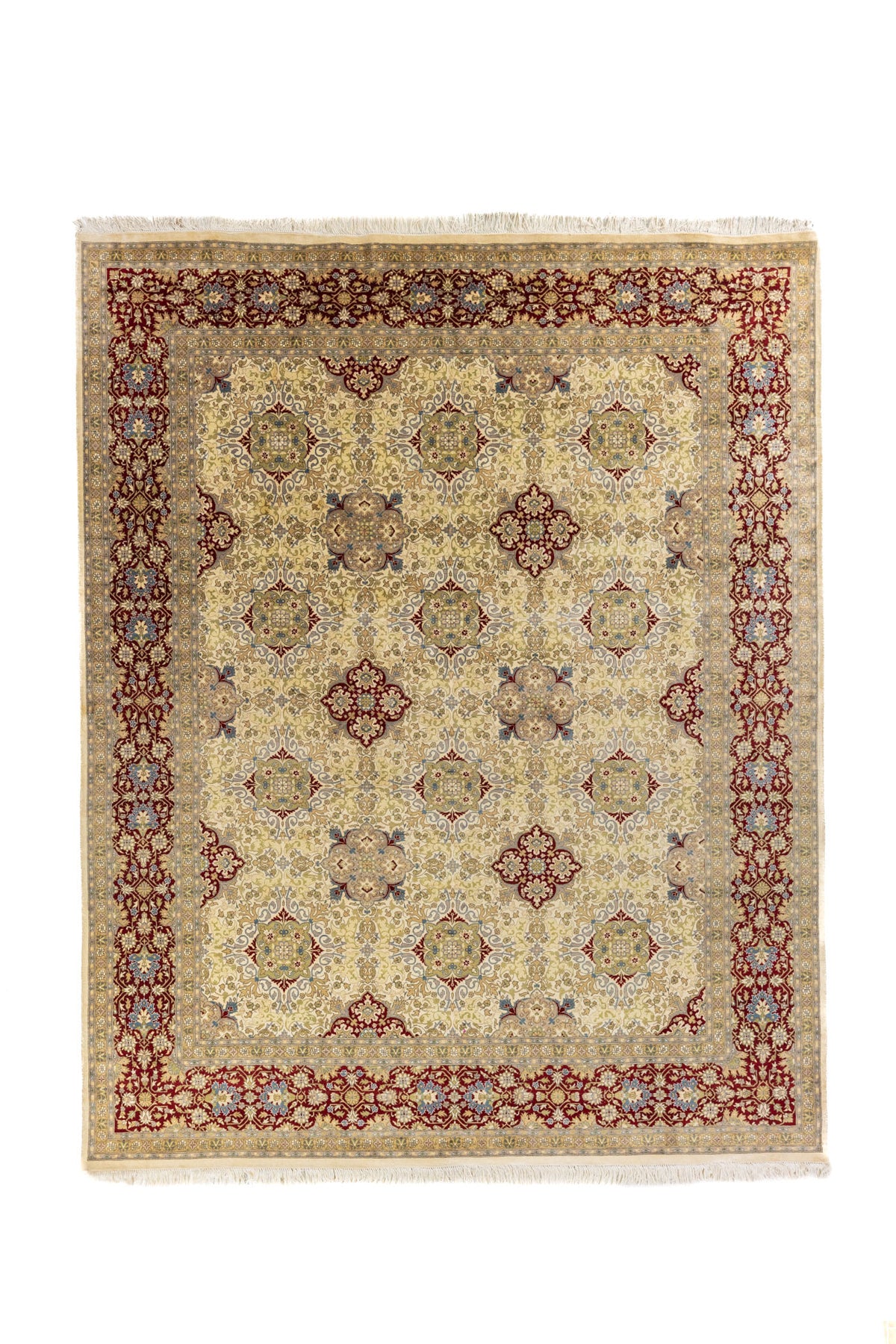 Alfombra clásica de diseño floral en tono beige con guarda roja vino y detalles azul claro, vista completa frontal.