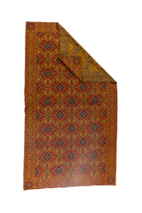 Textil decorativo dorado con reverso estampado y diseño geométrico tradicional para living o sofá